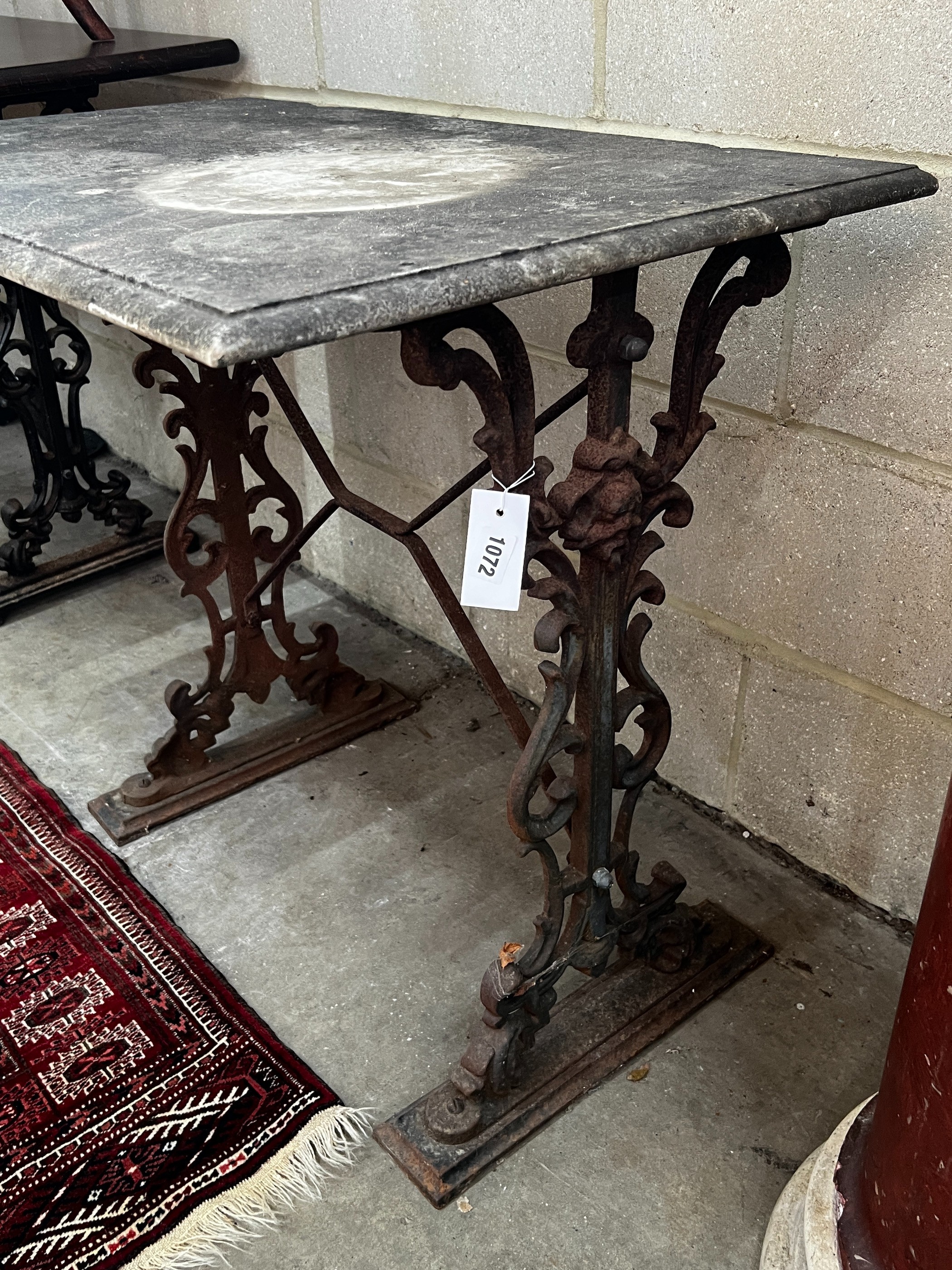 A rectangular cast iron marble topped garden table, length 92cm, depth 54cm, height 69cm